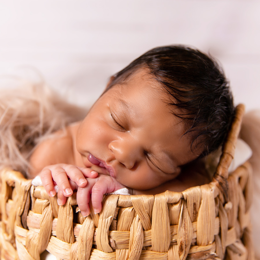 Newborn baby in basket prop