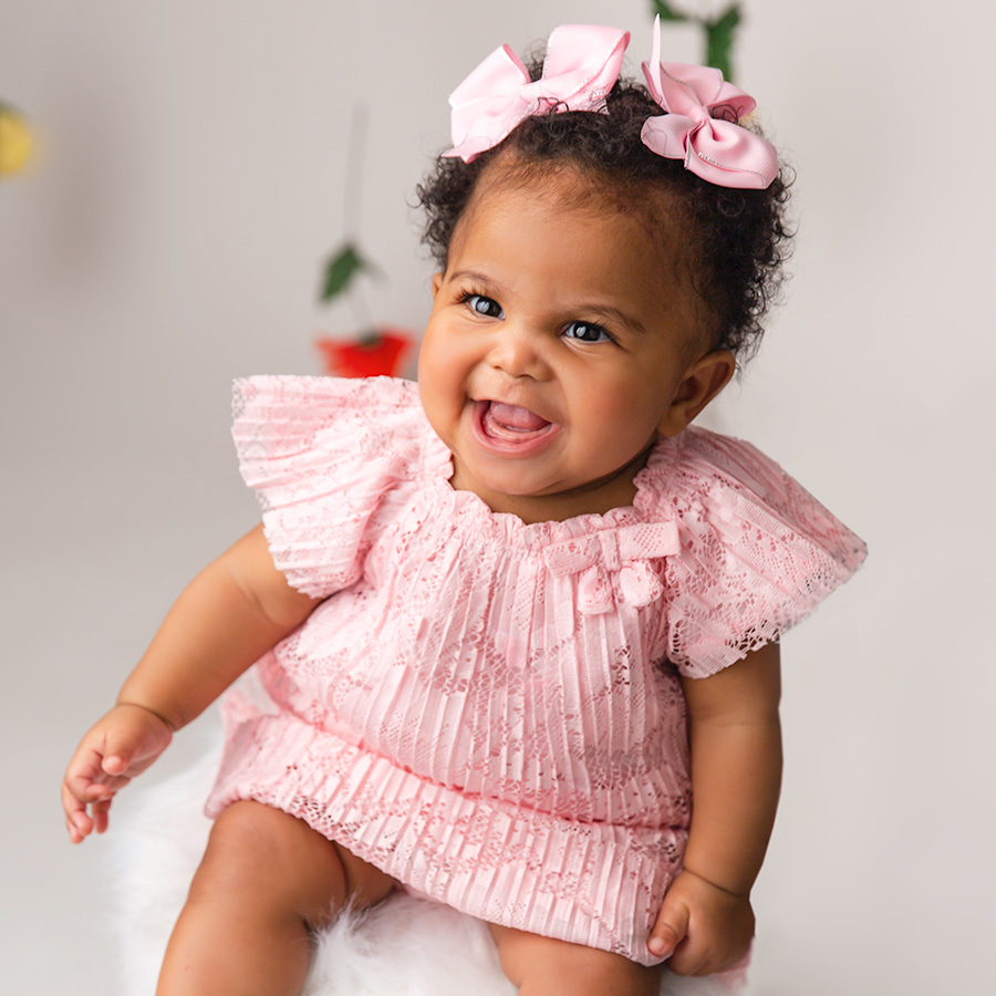 baby girl laughing in pink pace dress with pink bows| DMV sitter session6 month sitter photo session