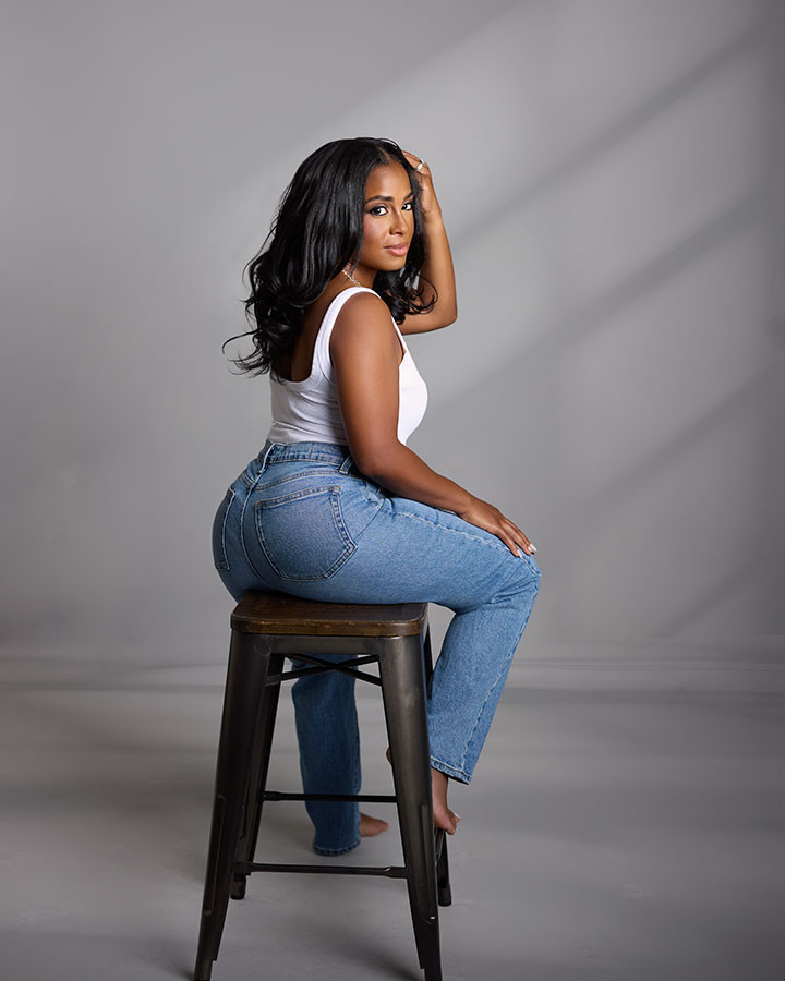 woman sitting backwards on a stool
