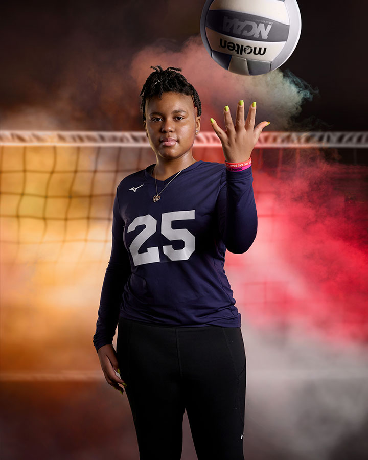 teenage girl posing with a volleyball