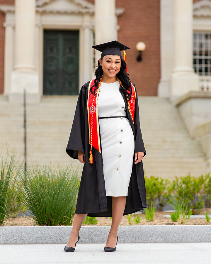 woman in her late 20s with cap and gown in Annapolis