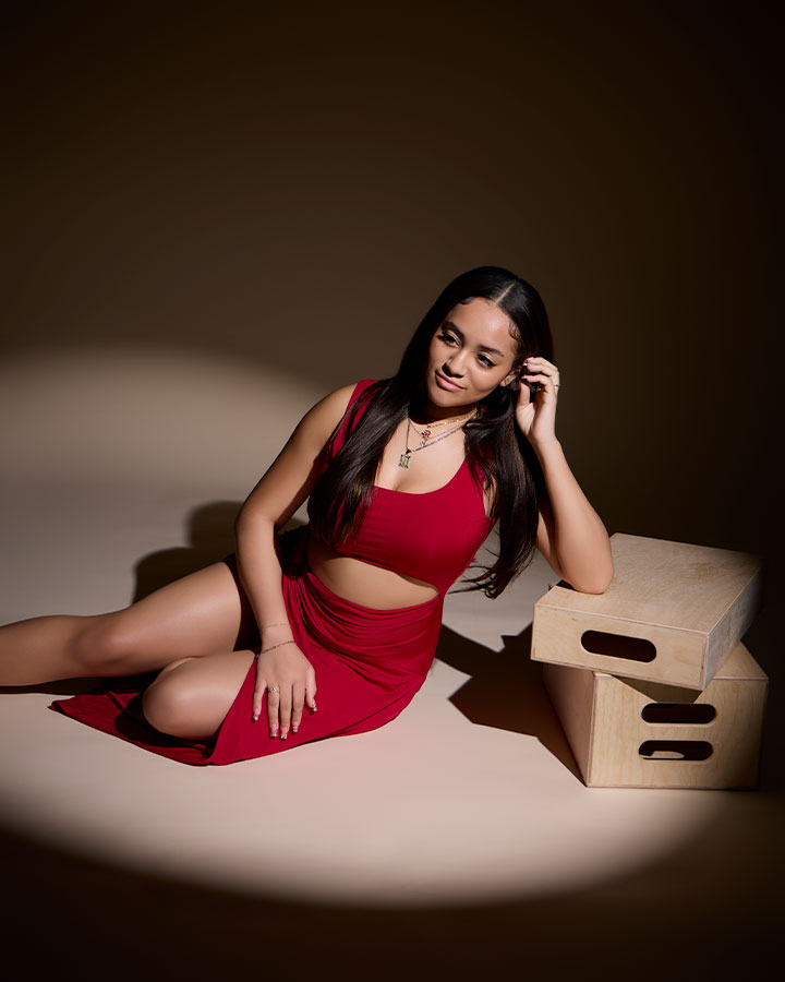 teen posing on the floor with wooden boxes