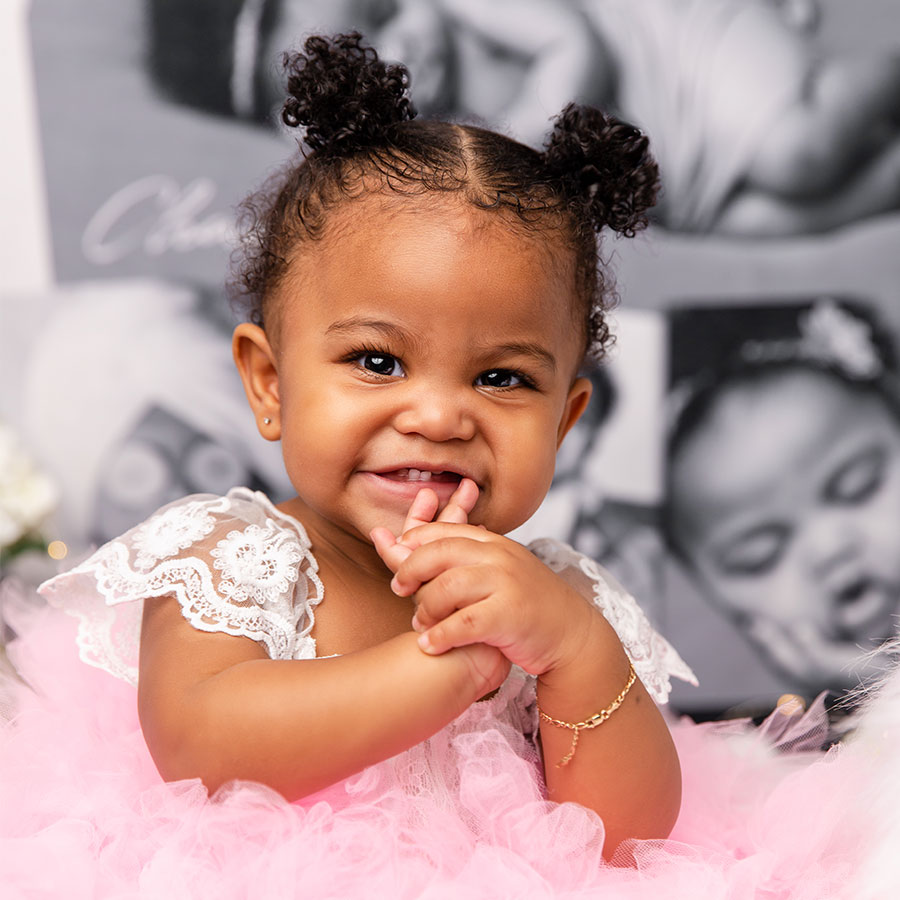 mixed baby girl smiling with tutu