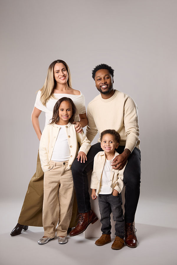 Studio portrait of a Black family in Maryland with soft neutral backdrop